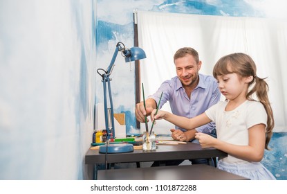 Portrait of caucasian father teaching his daughter little girl to paint and draw water color picture. Home school learn from teacher, education activities family love single dad father’s day concept.