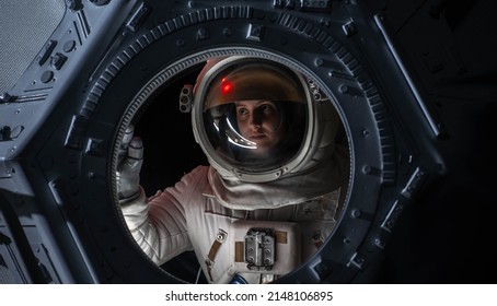 Portrait Of Caucasian Female Astronaut Flying Towards Spaceship Cupola Window. Space Exploration, Mars Mission