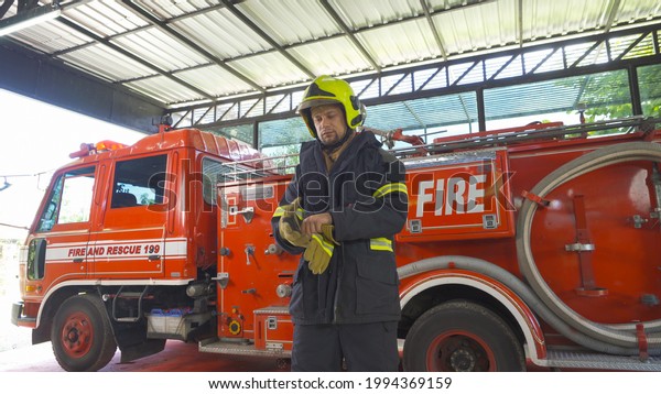 Portrait of a\
caucasian firefighter or fireman man with uniform, working on their\
career. An emergency accident rescue. People. Hero with a fire\
truck or ambulance car. Service\
job