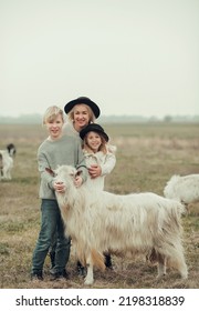 Portrait Of Caucasian Happy Farmer Family Family Business At Ecological Farm. Industrial Production Of Goat Milk Dairy Products. Cattle Farming.