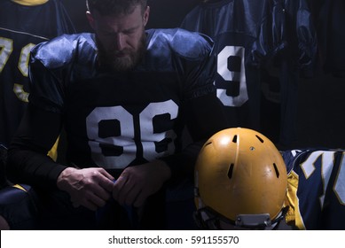 Portrait of Caucasian male American football player preparing for a game in a locker room - Powered by Shutterstock