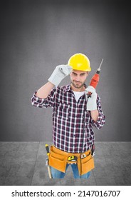 Portrait Of Caucasian Male Worker Holding A Drill Machine Against Copy Space On Grey Background. Repair Service Concept