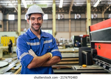 Portrait of Caucasian man industry worker working in factory warehouse. Attractive male industrial engineer processes orders and products alone at manufacturing plant then looking at camera with smile - Shutterstock ID 2176792483