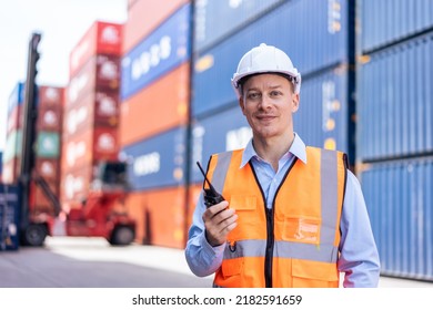 Portrait Of Caucasian Man Worker Working In Container Port Terminal. Attractive Male Engineer People Process Orders And Product At Warehouse Logistic In Cargo Freight Ship For Import Export In Harbor.