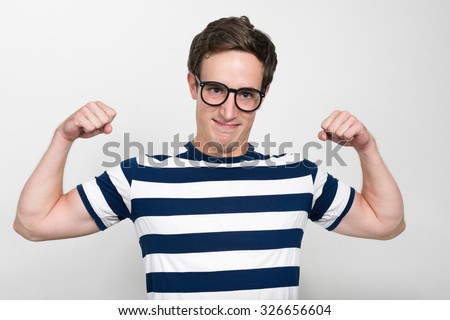 Portrait of Caucasian nerd flexing his biceps