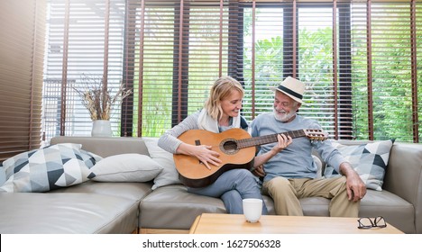 Portrait of caucasian senior grand parent couple enjoy practising guitar. Married mature man woman enjoying playing on music instrument. Love together valentines' day of old people Lifestyle banner
 - Powered by Shutterstock