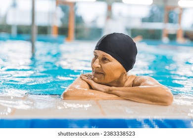 Portrait of a Caucasian senior woman relaxing at swimming pool, happy elder. High quality photo - Powered by Shutterstock