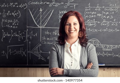 Portrait Of Caucasian Teacher And Blackboard