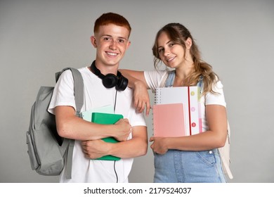 Portrait of caucasian teenage girl and boy holding school books and wearing schoolbags - Shutterstock ID 2179524037