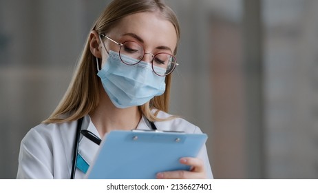 Portrait Caucasian Woman Doctor Nurse In Medical Protective Mask Writing Information In Medical Registration Journal Female In Glasses Therapist Working Clinic Hospital Handwriting Notes Appointment