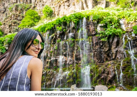 Portrait of caucasian woman look to camera with dramatic Dashbashi canyon watefall in background