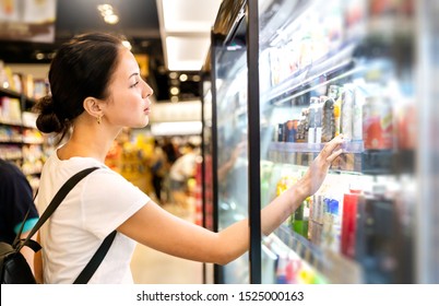 Portrait Of Caucasian Woman Looking At Product At Grocery Store. Happy Hispanic Girl Shopping In Supermarket Reading Product Information. Costumer Buying Food At The Market, Woman Lifestyle Concept.