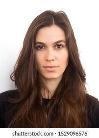 Portrait of caucasian woman with no expression. ID or passport photo full collection of diverse face and expressions. Calm interesting woman in black shirt with normal face expression