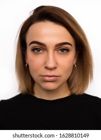Portrait of caucasian woman with no expression. ID or passport photo full collection of diverse face and expressions. Calm interesting woman in black shirt with normal face expression. Short hair.