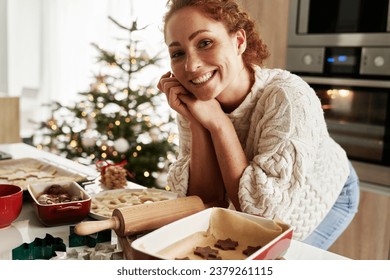 Portrait of caucasian woman preparing gingerbread cookies for Christmas - Powered by Shutterstock