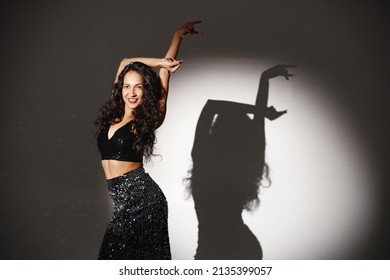 Portrait Of Caucasian Woman Salsa Dancer Under A Projector's Light