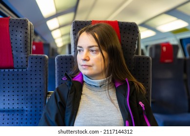 Portrait Of Caucasian Woman Traveler Sitting Inside Train.