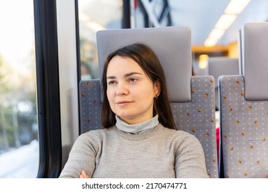 Portrait Of Caucasian Woman Traveler Sitting Inside Train.