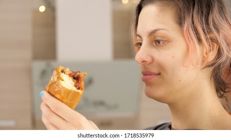 Portrait Of Caucasian Young Beautiful Woman Greedily Eagerly Eating Food During Quarantine Due To Coronavirus. Charming Happy Hungry Woman On Diet Laugh And Holds In Hands Big Meat Pie. Close Up.