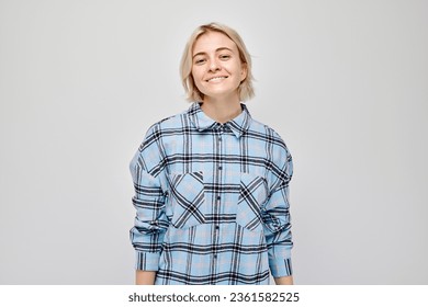 Portrait Caucasian young blond woman smiling joyfully isolated on white studio background. Happy girl in blue plaid shirt with glad face expression
 - Powered by Shutterstock