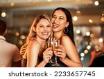 Portrait, champagne and clubbing with woman friends drinking alcohol in celebration of the new year. Party, diversity and event with a female and friend enjoying a drink together at a luxury social