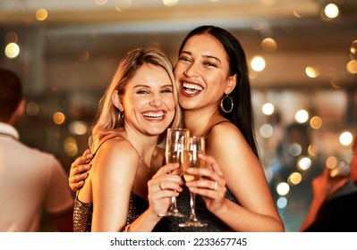 Portrait, champagne and clubbing with woman friends drinking alcohol in celebration of the new year. Party, diversity and event with a female and friend enjoying a drink together at a luxury social - Powered by Shutterstock