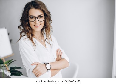 Portrait Of A Charismatic Business Woman In A White Shirt And In Glasses With A Beautiful Smile