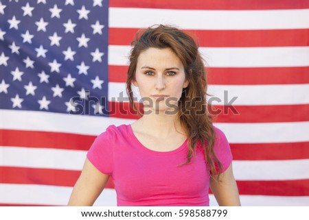 portrait of a charismatic caucasian american woman isolated on a U.S.A. flag