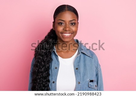 Portrait of charming adorable cheerful lady with long curly ponytail wear denim style isolated on pink color background