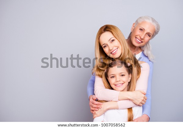 Portrait of charming beautiful friendly king\
supportive cute family members hugging each other isolated on gray\
background copyspace