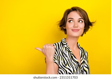 Portrait of charming cute lady showing offer empty space novelty wear print summer blouse isolated yellow color background - Shutterstock ID 2311311703