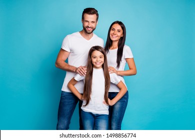 Portrait Of Charming Family Smiling Wearing White T-shirt Isolated Over Blue Background