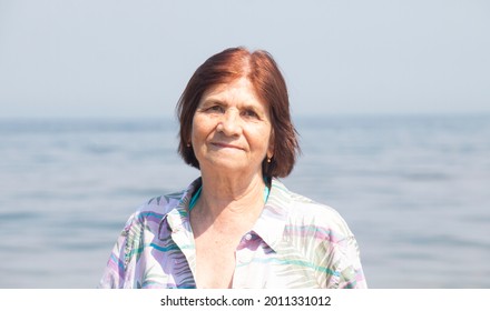 Portrait Of Charming Happy 72 Year Old Woman By The Sea In Summer On A Sunny Hot Day