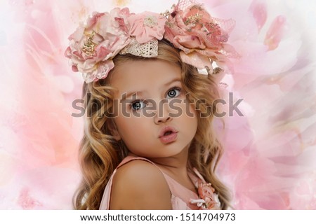 Portrait of a charming little girl with a wreath of roses.
