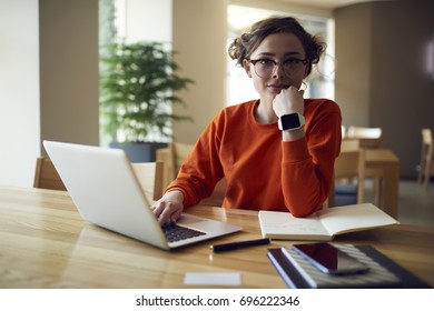 Portrait of charming young female journalist making remote job creating article on laptop computer connected to wireless internet in cafe, attractive student making researchers for doing homework - Powered by Shutterstock