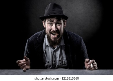 portrait of a cheeky bearded man in a hat with a cigar in his mouth