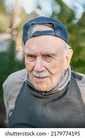 Portrait Of A Cheerful 88-year-old Man In A Baseball Cap. Happy Active Old Age.