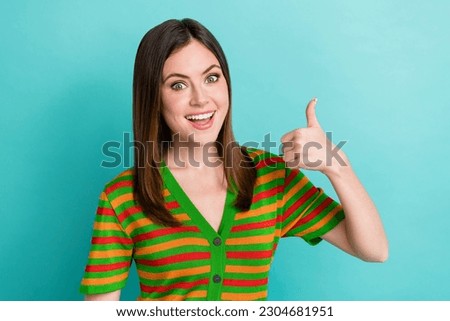 Portrait of cheerful adorable lady wear stylish clothes thumb up promoting new collection quality outfit isolated on cyan color background