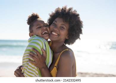 Portrait of cheerful african american mother and daughter with cheek to cheek at beach on sunny day. unaltered, family, lifestyle, togetherness, enjoyment and holiday concept. - Shutterstock ID 2142332495