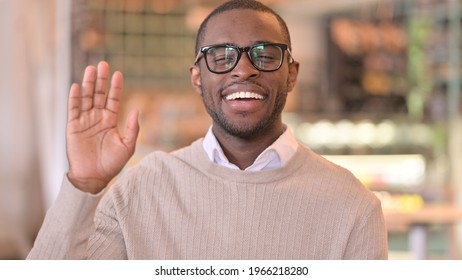 Portrait of Cheerful African Man Waving at the Camera 