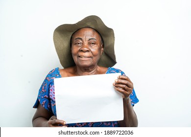 portrait of cheerful african old woman with white empty sheet, thumbs up sign- indoor concept