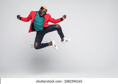 Portrait Of A Cheerful Afro American Man Jumping Isolated On A White Background