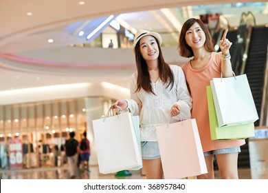 Portrait Of Cheerful Asian Girls Shopping In A Mall