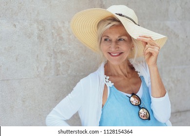 Portrait Of Cheerful Attractive Mature Blonde Woman Wearing Summer Hat