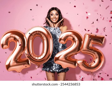 Portrait of a cheerful beautiful girl wearing sparkle dress standing under confetti rain and celebrating isolated over pink background. Happy New year 2025 - Powered by Shutterstock