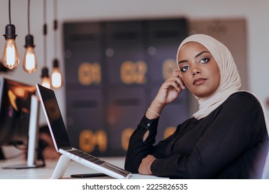 Portrait of cheerful business African-American muslim lady working on laptop - Powered by Shutterstock