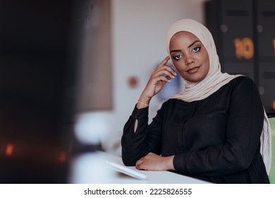 Portrait of cheerful business African-American muslim lady working on laptop - Powered by Shutterstock