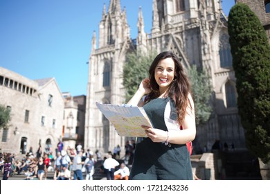 Portrait of cheerful caucasian female traveler excited with interesting vacations exploring european city, smiling beautiful woman 20s standing on square holding map for navigate and get to landmarks - Shutterstock ID 1721243236