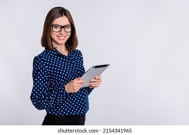 Portrait of cheerful charming girl hold tablet toothy smile empty space isolated on grey color background - Shutterstock ID 2154341965