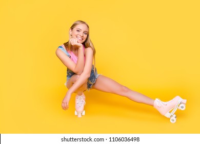 Portrait of cheerful charming girl sitting on roller skates making break time out pause looking at camera isolated on yellow background - Shutterstock ID 1106036498